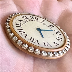 Bob Benson studio button of of a clock face.