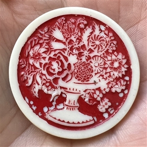 Artid Vintage plastic button of a flower arrangement.