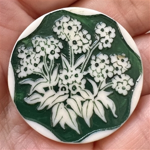 Artid Vintage plastic button of a flowering plant.