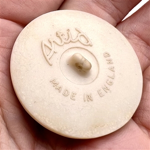 Artid Vintage plastic button of a flowering plant.