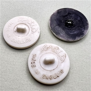 Three Artid Vintage plastic buttons of assorted subjects.