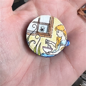 Movable show favor button of “Little Miss Muffet by Grace Bauman.