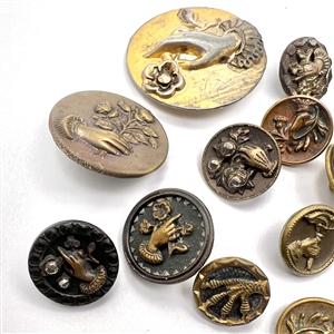 Twenty one assorted brass buttons of hands holding flowers.