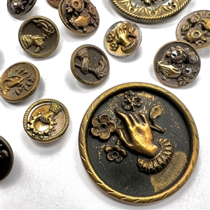 Twenty one assorted brass buttons of hands holding flowers.