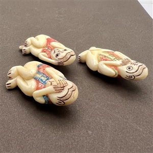 Set of three carved natural material buttons of “see, hear and speak no evil.”