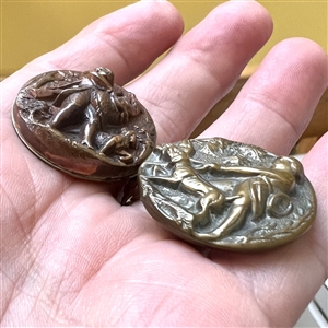 Two French brass sporting buttons of men hunting with dogs.