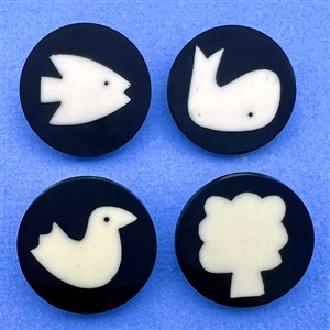 Four polyester cookie buttons of assorted subjects.