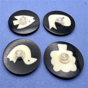 Four polyester cookie buttons of assorted subjects.