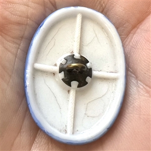 Milk glass rosette shank button with blue of woman’s head.