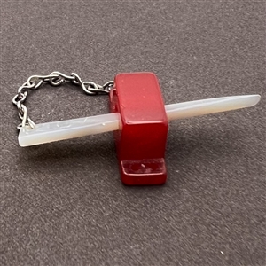 Vintage snapette trim of Bakelite base with shell sword.