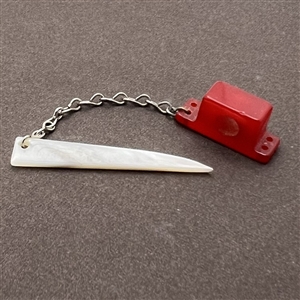 Vintage snapette trim of Bakelite base with shell sword.