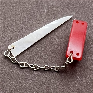 Vintage snapette trim of Bakelite base with shell sword.