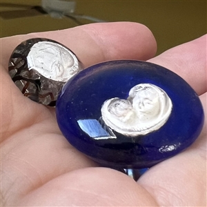 Two paperweight glass buttons with sulfides.