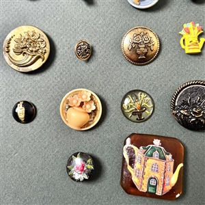 Card of twenty seven container buttons.