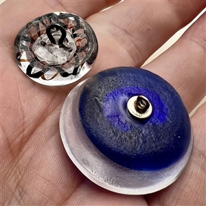 Two paperweight glass buttons with sulfides.
