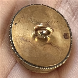 Reverse-painted architectural scene under glass set in gilded metal button.