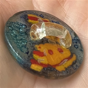 Contemporary fused glass button from an artist in Ecuador of a colorful butterfly.