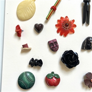 Card of thirty one celluloid buttons and trim.