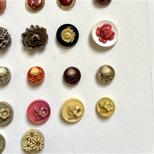 Card of twenty four celluloid buttons.