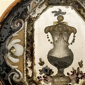 An 18th c. Reverse painted glass of an urn over silvered liner button.