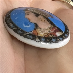 Liverpool transfer button of an Indian woman in a headdress.