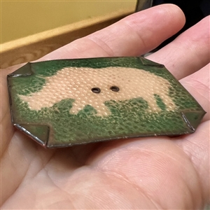 Enamel studio button of a rhinoceros.