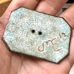 Enamel studio button of a rhinoceros.
