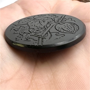 Matte and shiny button of plant with fruit.