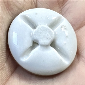 An 18th c. porcelain button of roses and unusual border.