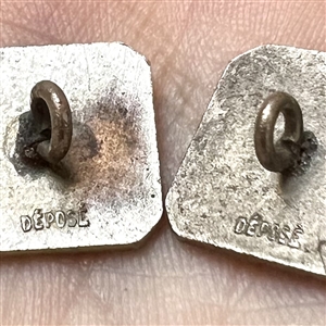Two 20th c. French silver buttons with enamel of a country couple smoking pipes.