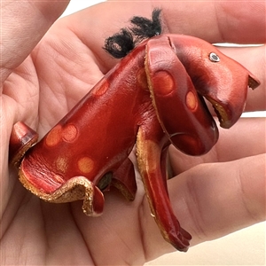 Large realistic leather button of a dog.