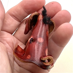 Large realistic leather button of a dog.