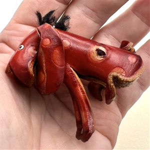 Large realistic leather button of a dog.