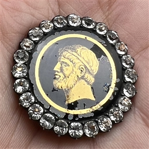 An 18th c. Transitional églomisé of Zeus with paste border in silver button.