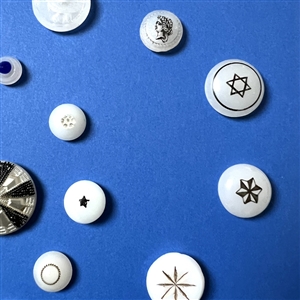Card of 34 assorted clam broth glass buttons.