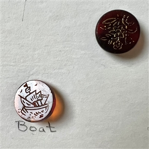 Card of 30 ruby and red glass buttons.