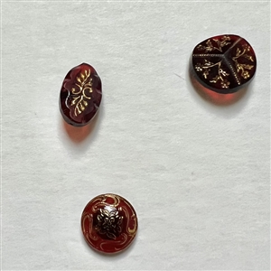 Card of 30 ruby and red glass buttons.