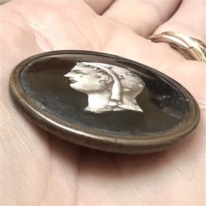 A 19th c. Liverpool transfer button of woman wearing a scarf of stars.