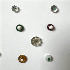 Card of 35 small and diminutive glass swirl back buttons.