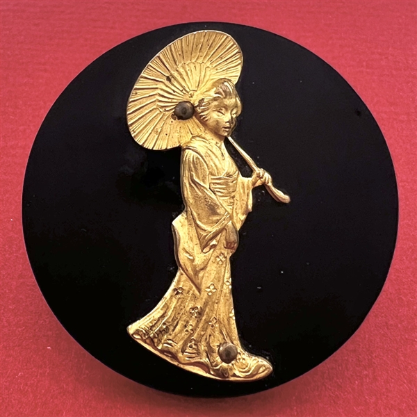 Extra large Vintage casein button with gilded escutcheon of a geisha.