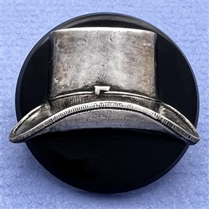 Vintage casein button with silvered metal escutcheon of a top hat.