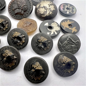 Group of 24 assorted horn and wood buttons. 