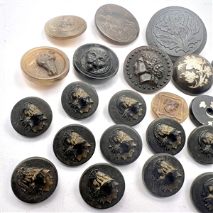 Group of 24 assorted horn and wood buttons. 