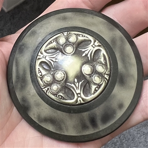 Huge celluloid tight top button with an Ivoroid center.