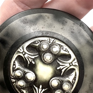 Huge celluloid tight top button with an Ivoroid center.