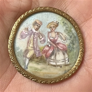 A 19th c. Polychrome painting on natural material of a couple under glass button.