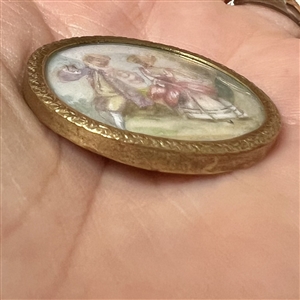 A 19th c. Polychrome painting on natural material of a couple under glass button.