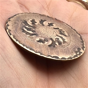An 18th c. heavily chased copper Colonial button.