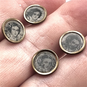 Four tiny tintype buttons of women.