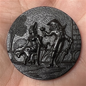 A 19th c. Large molded black horn button of FOP couple.